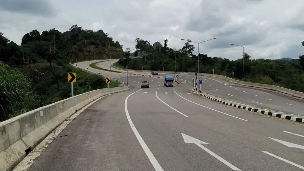 Curving highway through green hills in Thailand